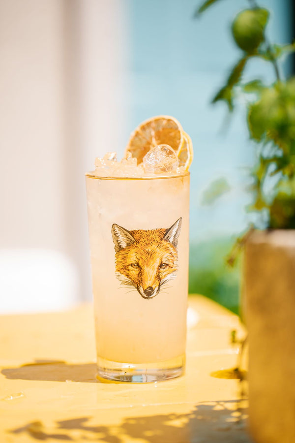 Close up of Foxy Lemonade cocktail in tall cocktail glass with fox on it