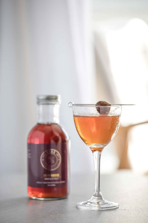 Close up shot of I Love You Manhattan cocktail and Kvas Cherry Hibiscus Simple Syrup