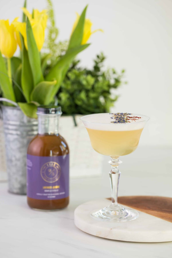 Closeup of Pai Mei cocktail with bottle of Kvas Lavender Jasmine Simple Syrup