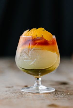 Close up of beautifully crafted non-alcoholic Cat Tail cocktail in glass with garnish