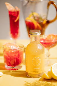 Closeup of Kvas Whisky Sour syrup next to craft cocktail