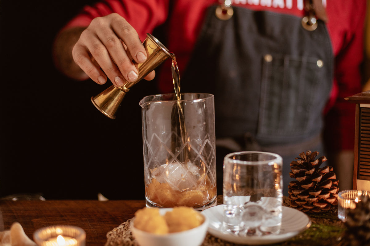 bartender pouring quality cocktail syrup into cocktail